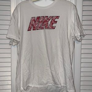 White “The Nike Tee” T-shirt with dark pink palm tree design wording